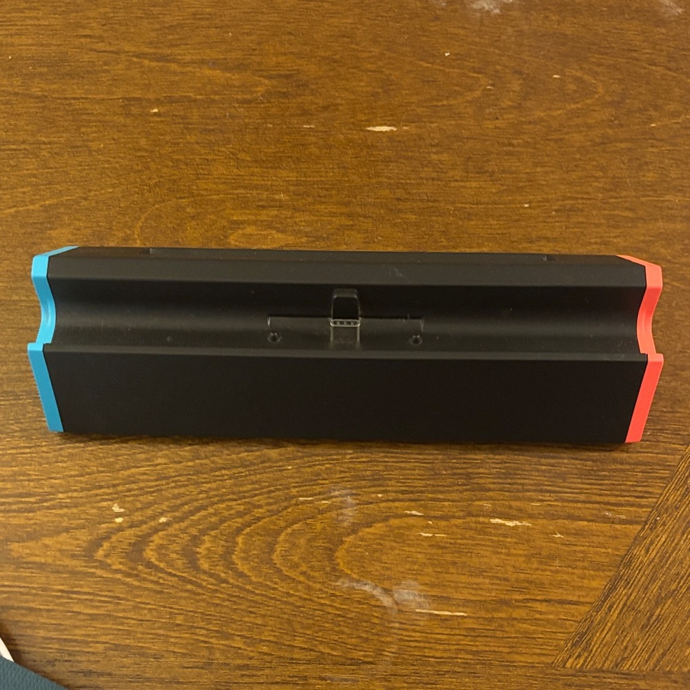 Black Gaming Console Dock with Red and Blue Accents